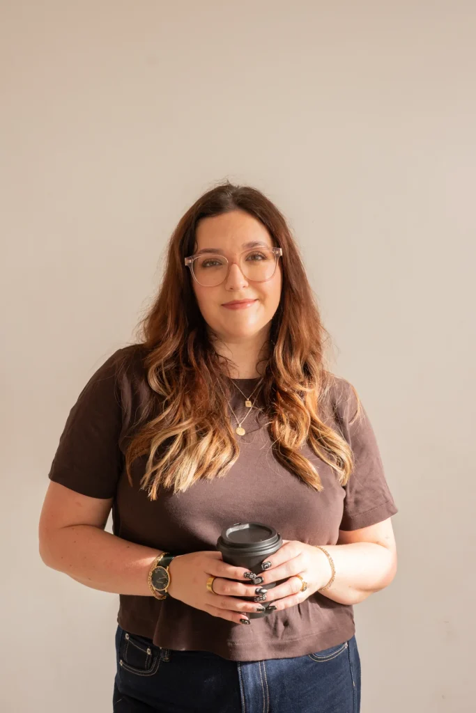 Jaye Rockett holding a takeaway coffee cup